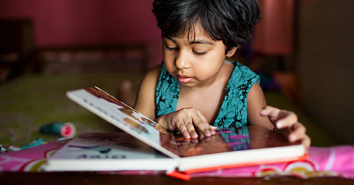 toddler_reading_book-1200x628-facebook-1200x628-1.webp