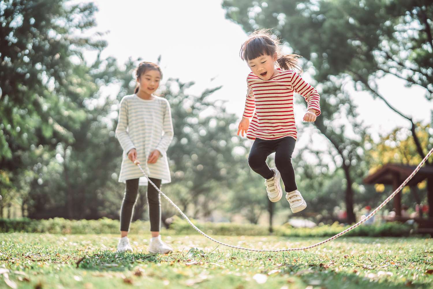 young-family-jumping-rope-joyfully-on-the-lawn-1215744796-08b5ef6c45c647f3aece9fc24948caf8.jpg